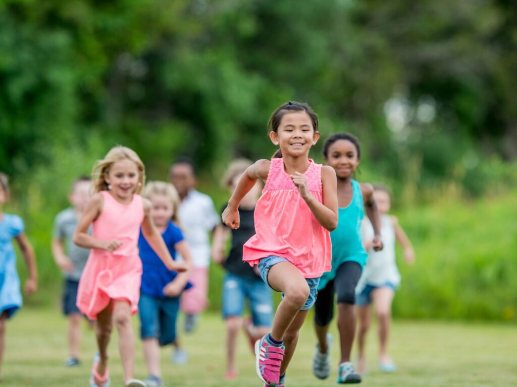 Children running comfortably outdoors while wearing pediatric orthotics