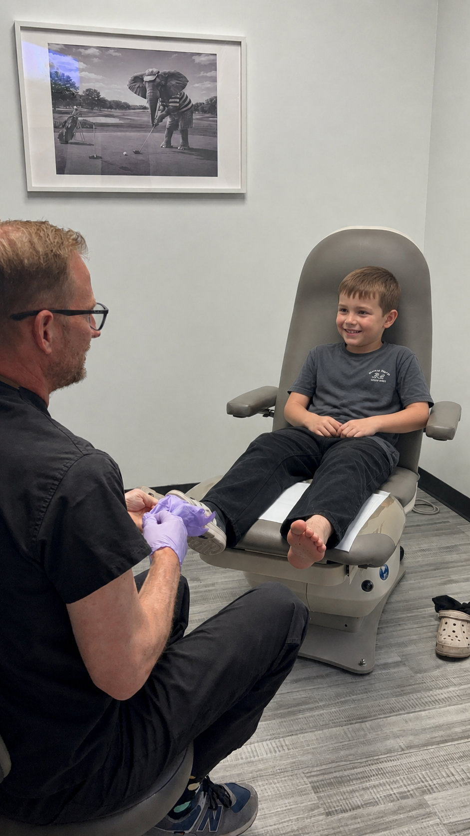 Dr. Jarman fitting a young patient with a pediatric orthotic in the exam chair