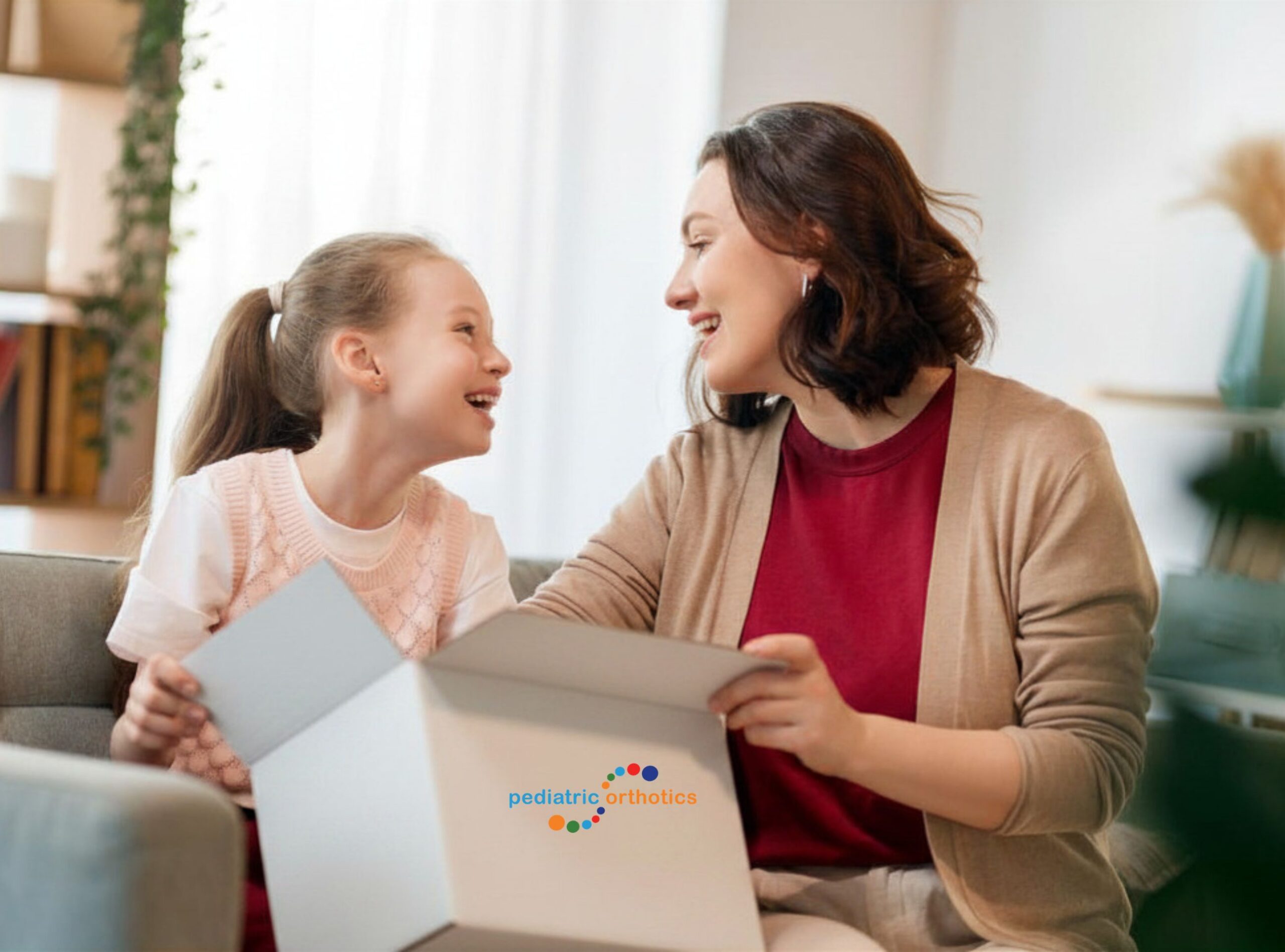 Mother and daughter opening a Pediatric Orthotics home molding kit box
